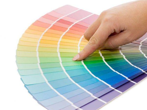 Woman hand pointing to a sample color chart